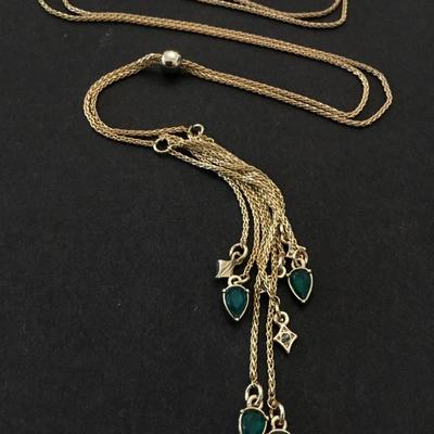 Very nice vintage gold toned, green rhinestone slider tassel necklace very beautiful. Very nice.