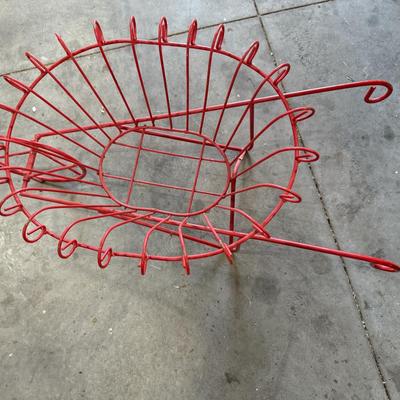 Red wrought iron wheelbarrow flower basket