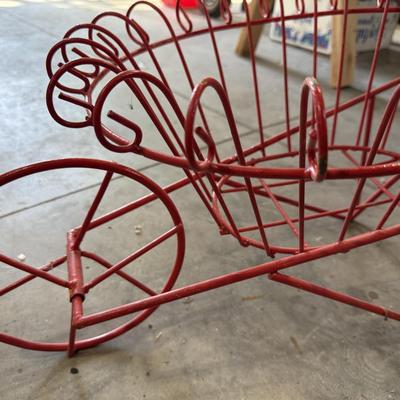 Red wrought iron wheelbarrow flower basket