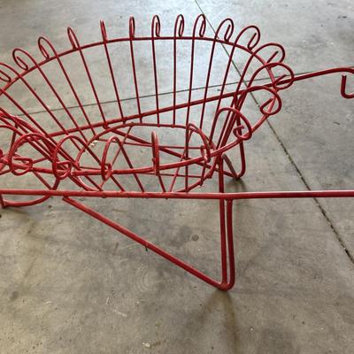 Red wrought iron wheelbarrow flower basket