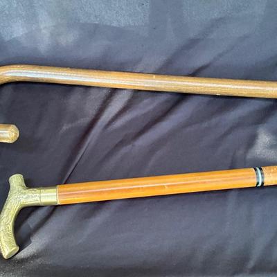 Vintage walking canes, one with brass handle