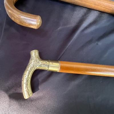 Vintage walking canes, one with brass handle
