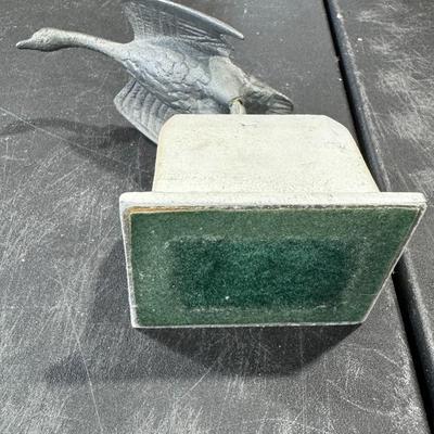 Metal goose in flight statue
