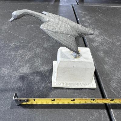 Metal goose in flight statue