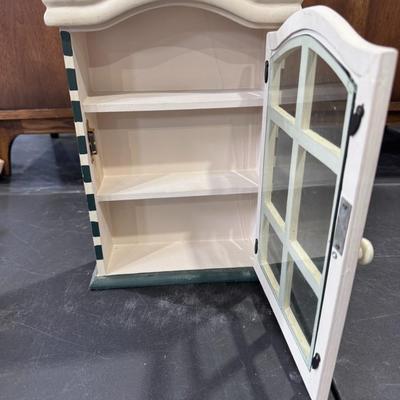 Decorative miniature cabinet with shelves and a glass door