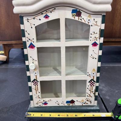 Decorative miniature cabinet with shelves and a glass door