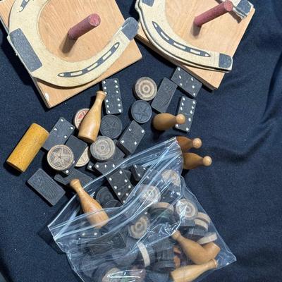 Dominos with wooden pegs, and cardboard horse shoes.