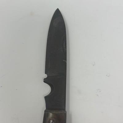 Sale Photo Thumbnail #433: Puma Solingen German WWII pocket knife. It has a wood handle and an eagle with swastika emblem attached. Very good condition.