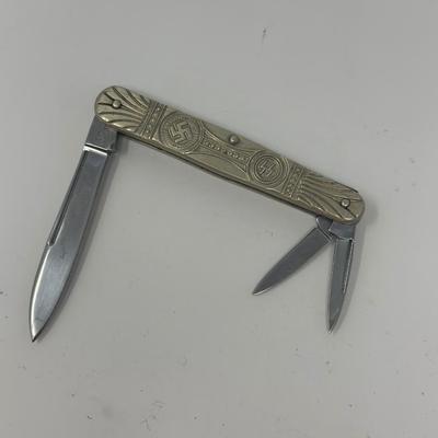 Sale Photo Thumbnail #460: In like new condition. Pre WWII elections SS pocket knife with embossed swastika and SS symbols.