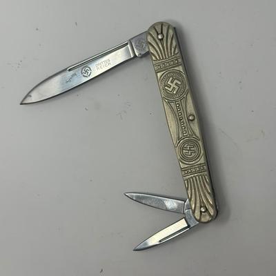 Sale Photo Thumbnail #459: In like new condition. Pre WWII elections SS pocket knife with embossed swastika and SS symbols.