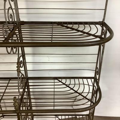 Sale Photo Thumbnail #488: This solid French bakers rack by dated from circa 1890-1910 is made of iron and wrapped in unlaquered brass trim by Echalie and Biabaud, Paris embossed on the cast iron feet. Scroll iron decor, sheaves of wheat adorn the top. The left side of this rack sl