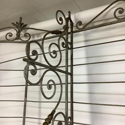 Sale Photo Thumbnail #484: This solid French bakers rack by dated from circa 1890-1910 is made of iron and wrapped in unlaquered brass trim by Echalie and Biabaud, Paris embossed on the cast iron feet. Scroll iron decor, sheaves of wheat adorn the top. The left side of this rack sl