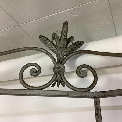 Sale Photo Thumbnail #487: This solid French bakers rack by dated from circa 1890-1910 is made of iron and wrapped in unlaquered brass trim by Echalie and Biabaud, Paris embossed on the cast iron feet. Scroll iron decor, sheaves of wheat adorn the top. The left side of this rack sl