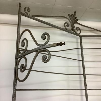 Sale Photo Thumbnail #486: This solid French bakers rack by dated from circa 1890-1910 is made of iron and wrapped in unlaquered brass trim by Echalie and Biabaud, Paris embossed on the cast iron feet. Scroll iron decor, sheaves of wheat adorn the top. The left side of this rack sl