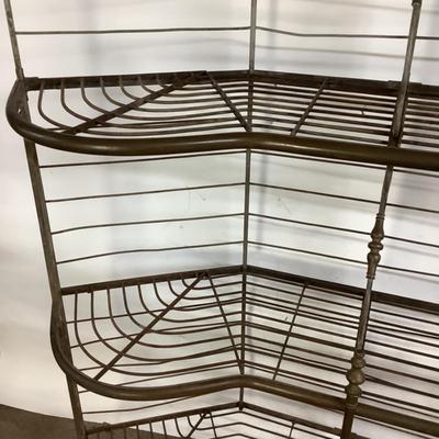 Sale Photo Thumbnail #489: This solid French bakers rack by dated from circa 1890-1910 is made of iron and wrapped in unlaquered brass trim by Echalie and Biabaud, Paris embossed on the cast iron feet. Scroll iron decor, sheaves of wheat adorn the top. The left side of this rack sl
