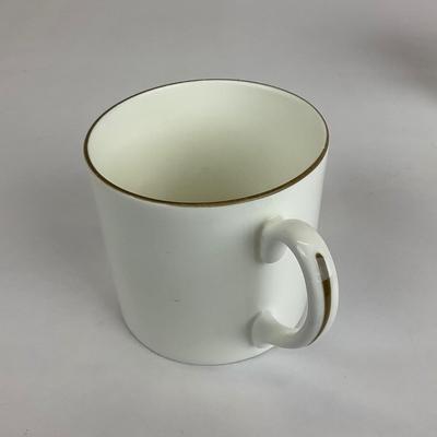 Sale Photo Thumbnail #527: Comes with hand-painted giraffe mug, an all white mug, and a gold trim all Tiffany & co. 
Measurement of giraffe mug is 4.5” in height