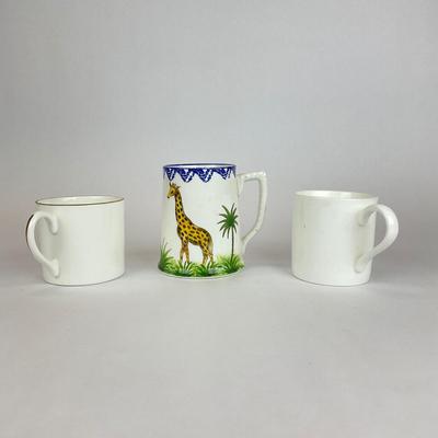 Sale Photo Thumbnail #526: Comes with hand-painted giraffe mug, an all white mug, and a gold trim all Tiffany & co. 
Measurement of giraffe mug is 4.5” in height