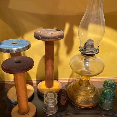 Vintage spools, oil lamp, and insulators