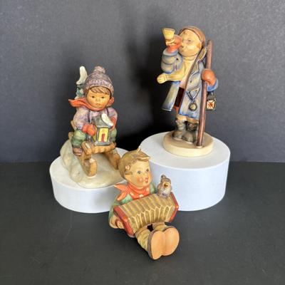 LOT 91: Hummel Figurines: Hear Ye Hear Ye, Let's Sing & Ride into Christmas