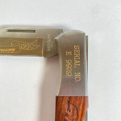 LOT 159: Kershaw 70th Anniversary Knives Serial No. E 1504 and E 9929, Sheaths and Pewter Pete Kershaw Numbered Belt Buckle