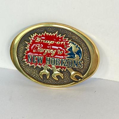 LOT 196: Pair of Snap-on Belt Buckles - Charging to New Horizons (Solid Brass) and Snap-on (Chrome on Solid Brass)