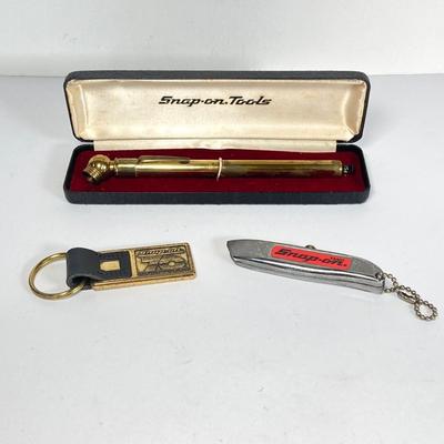 LOT 199: Snap-on Tools "The Master's Choice" Brass Tire Gauge, 70th Anniversary Key Chain and Miniature Utility Knife