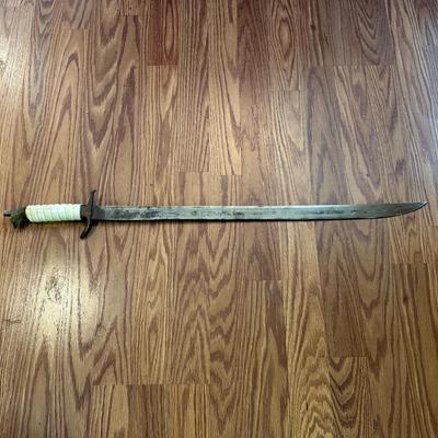 SWORD WITH AN ENGRAVED BLADE