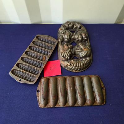 Sale Photo Thumbnail #74: 2-Cast iron corn molds
1 cast iron dinosaur mold
