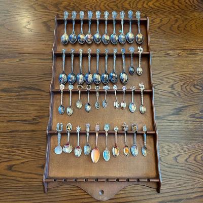 SOUVENIR SPOONS AND A WALL HUNG HOLDER