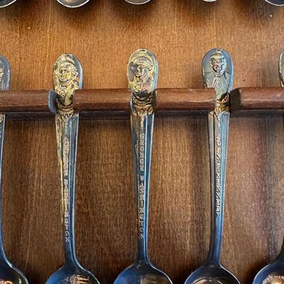 SOUVENIR SPOONS AND A WALL HUNG HOLDER