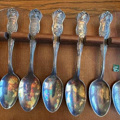 SOUVENIR SPOONS AND A WALL HUNG HOLDER