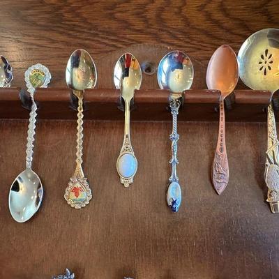 SOUVENIR SPOONS AND A WALL HUNG HOLDER