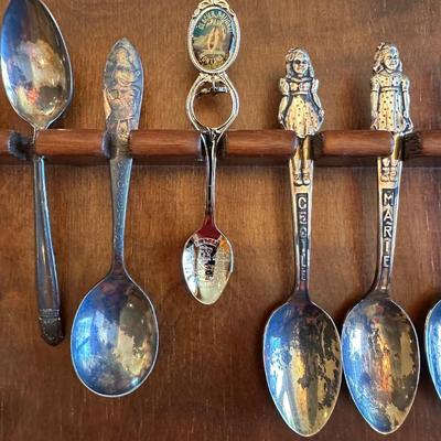 SOUVENIR SPOONS AND A WALL HUNG HOLDER
