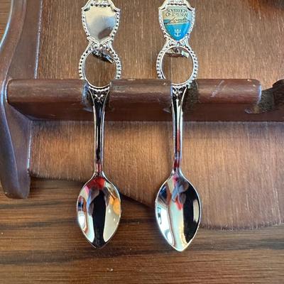 SOUVENIR SPOONS AND A WALL HUNG HOLDER