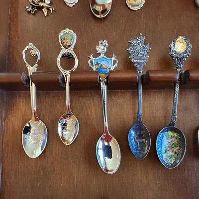 SOUVENIR SPOONS AND A WALL HUNG HOLDER