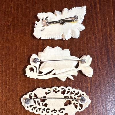 3 carved bone pins