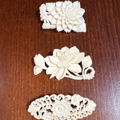 3 carved bone pins