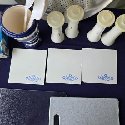 Sale Photo Thumbnail #86: Includes: 2 cutting boards
3 blue cornflower trivets(2 chipped)
Garlic press
2-Tupperware Salt & Pepper sets
Utensil holder
Pizza pan