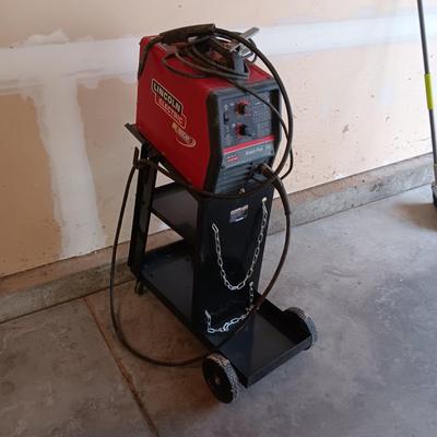 LINCOLN ELECTRIC WELD-PAK 100 WELDER ON A PORTABLE STAND