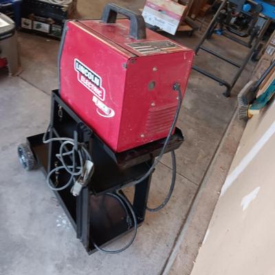 LINCOLN ELECTRIC WELD-PAK 100 WELDER ON A PORTABLE STAND