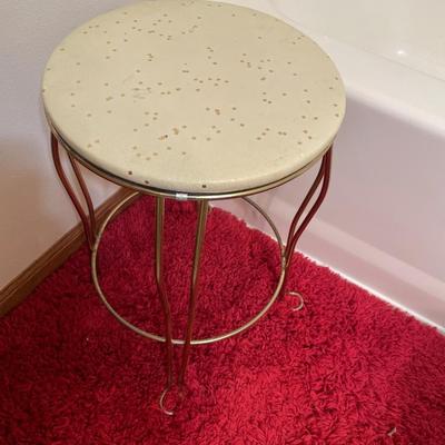 Small vanity stool and red rug