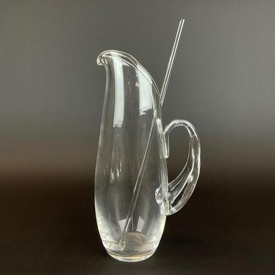 Sale Photo Thumbnail #912: designed by Lloyd Atkins model # 8077 comes with split handle includes stir stick. Pitcher does have scratches at bottom, please refer to photos.
Measurements:
10” in height, 3.5” in diameter
Handle sticks out 1.75”