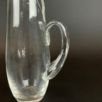 Sale Photo Thumbnail #916: designed by Lloyd Atkins model # 8077 comes with split handle includes stir stick. Pitcher does have scratches at bottom, please refer to photos.
Measurements:
10” in height, 3.5” in diameter
Handle sticks out 1.75”