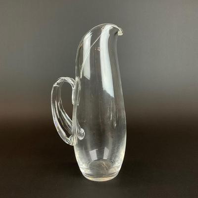 Sale Photo Thumbnail #914: designed by Lloyd Atkins model # 8077 comes with split handle includes stir stick. Pitcher does have scratches at bottom, please refer to photos.
Measurements:
10” in height, 3.5” in diameter
Handle sticks out 1.75”