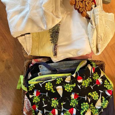2 baskets full of tablecloths, placemats, and towels