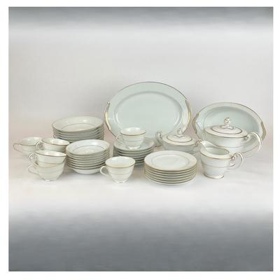 Sale Photo Thumbnail #943: This lot includes a tea pot, a creamer, sugar, 7 teacups, 7 saucers, 7 bread and butter dishes, 16 bowls 8 large bowls and 8 small bowls, one platter dish and one oval bowl.
Measurements of the large platter plate dish is 13” in length
