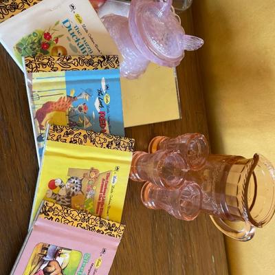 Pink mini glasses, mini books and two girl figures