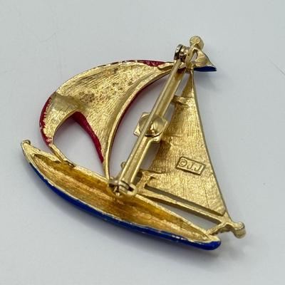LOT 82: Clay Floral Pin & Pendant, Sarah Coventry Apple Pin, JJ Sailboat Brooch & More