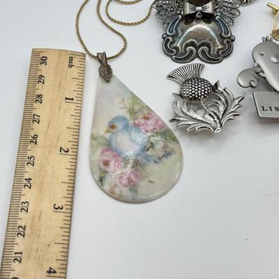 LOT 82: Clay Floral Pin & Pendant, Sarah Coventry Apple Pin, JJ Sailboat Brooch & More