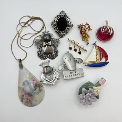 LOT 82: Clay Floral Pin & Pendant, Sarah Coventry Apple Pin, JJ Sailboat Brooch & More